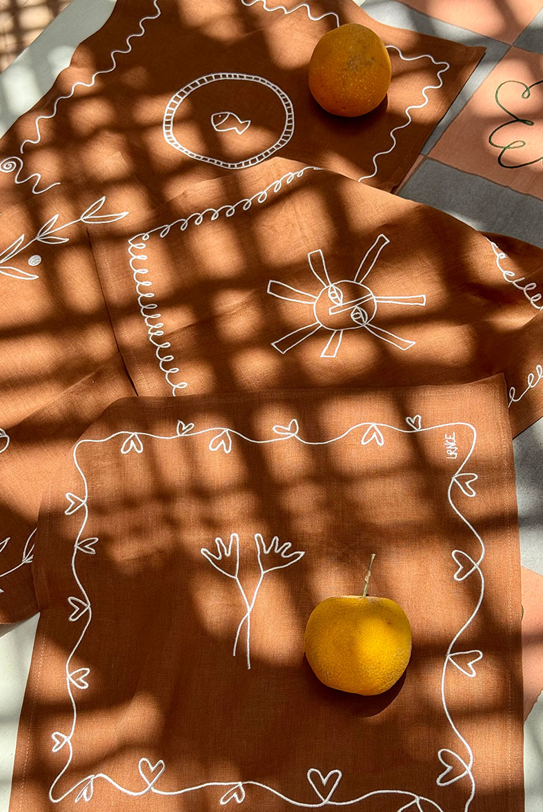 lrnce-textiles-tablelinen-sun,flowersterracotta
